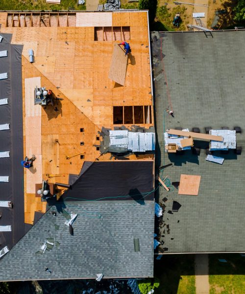 Construction worker on a renovation roof the house installed new shingles