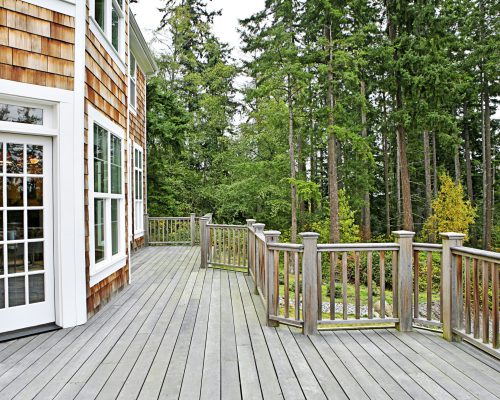 Wooden deck on house near forest